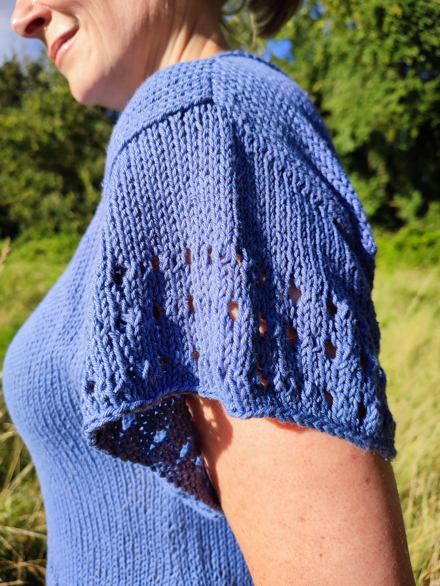 woman showing close up of eyelets on sleeve of OceansEdge Tee