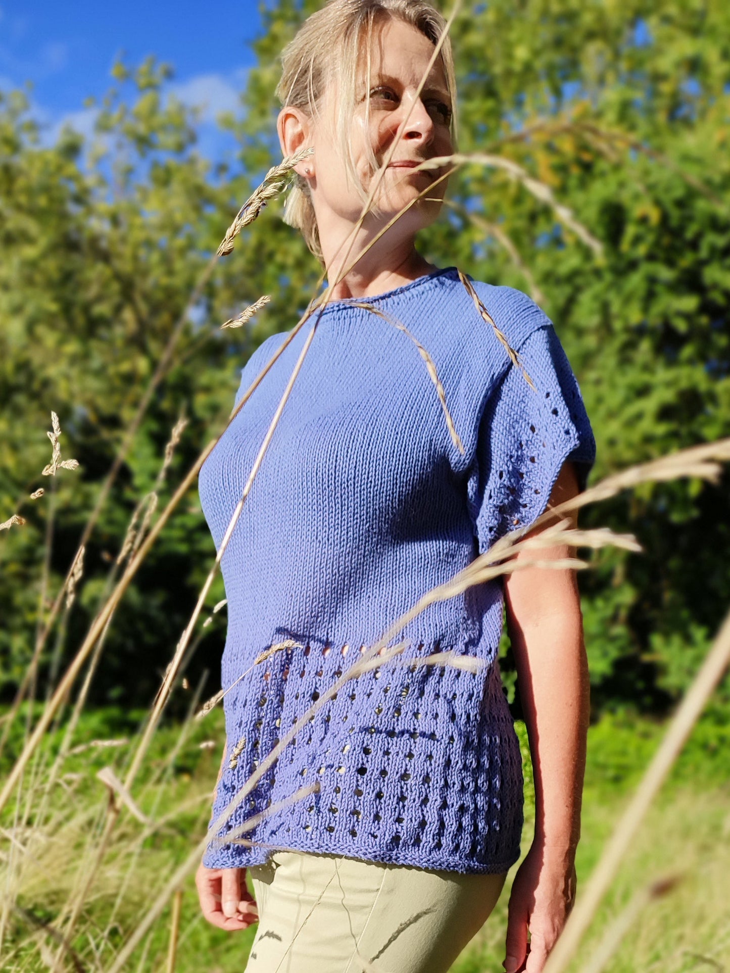 woman wearing eyelet lace tee standing in field