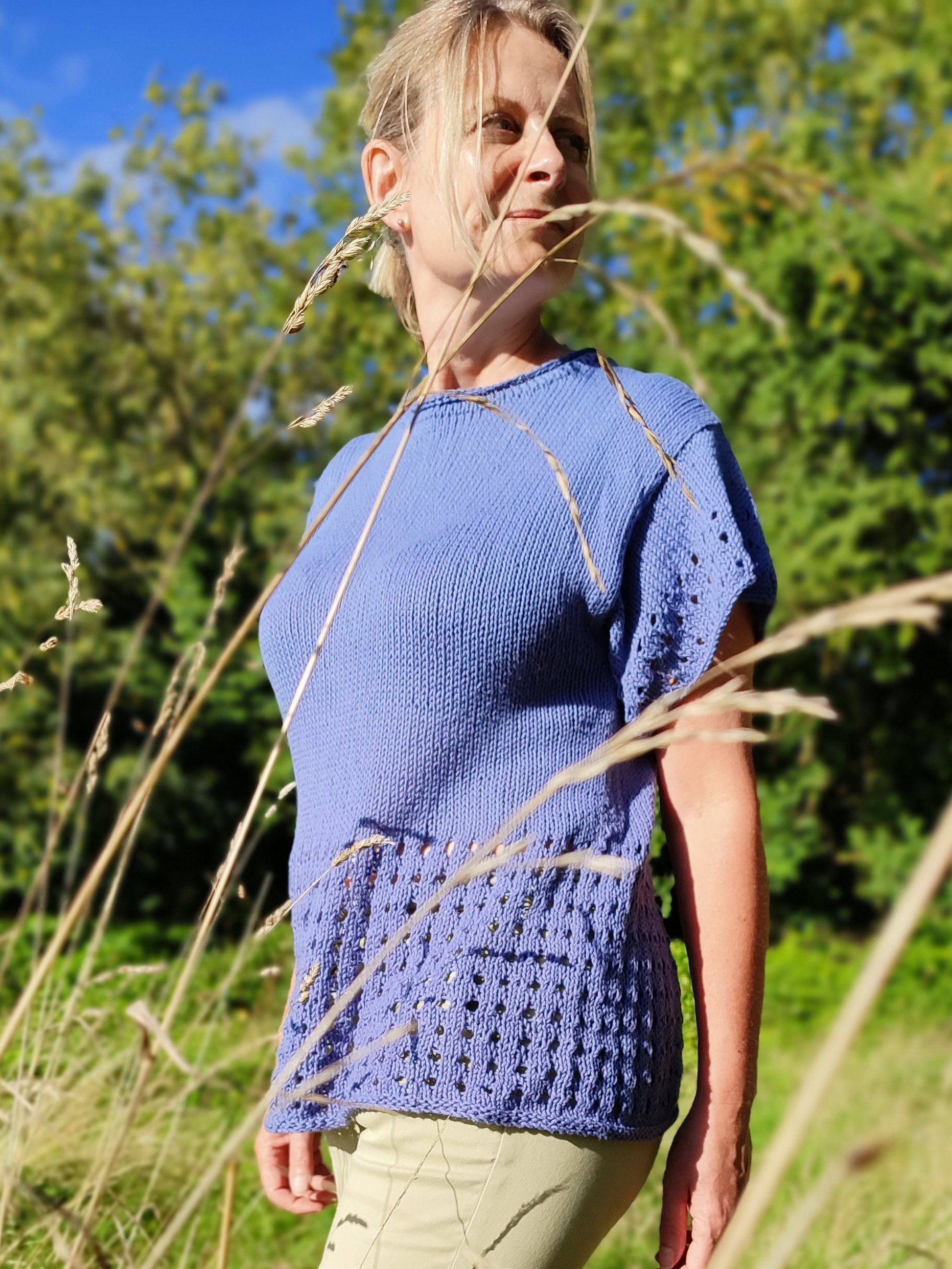 woman wearing eyelet lace tee standing in field