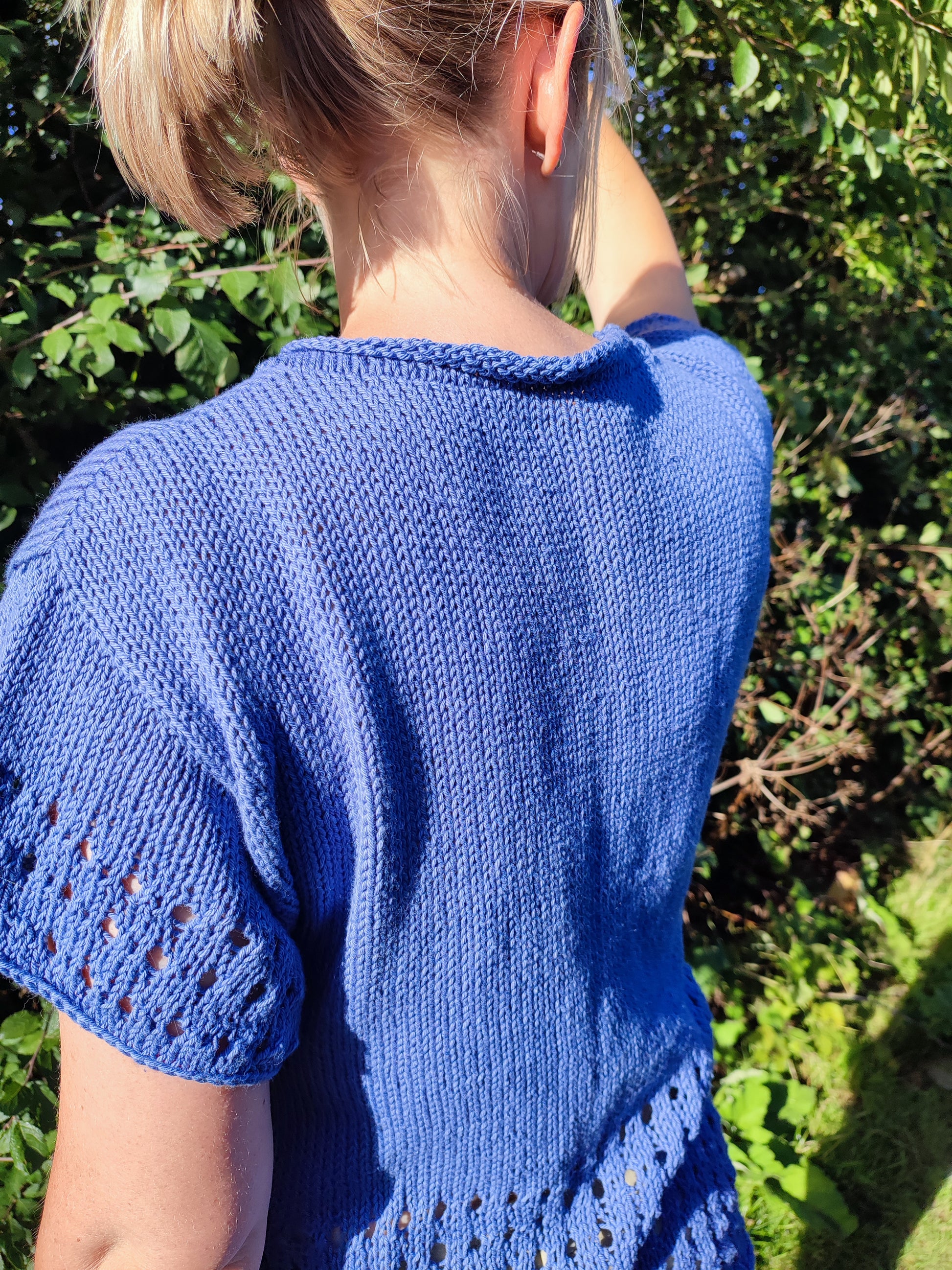 woman showing rolled neckline of lace eyelet Oceans Edge Tee